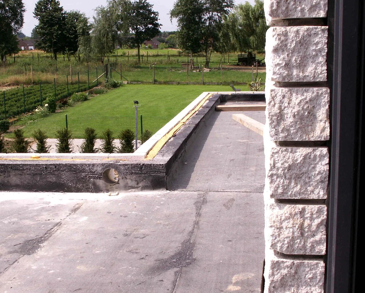 Low-slope roofing under construction with roof penetrations